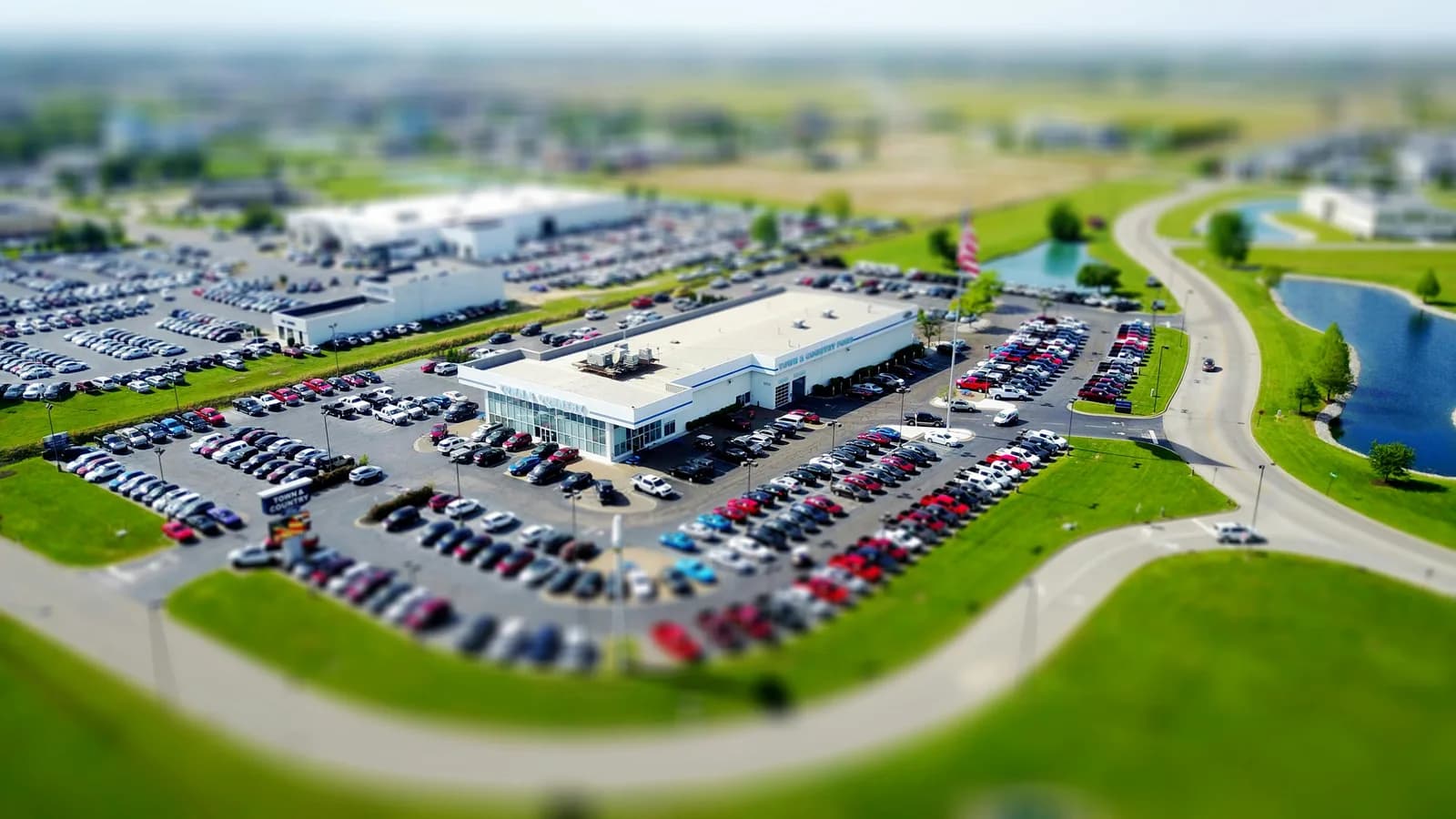 Car dealership showroom with sales team on phones